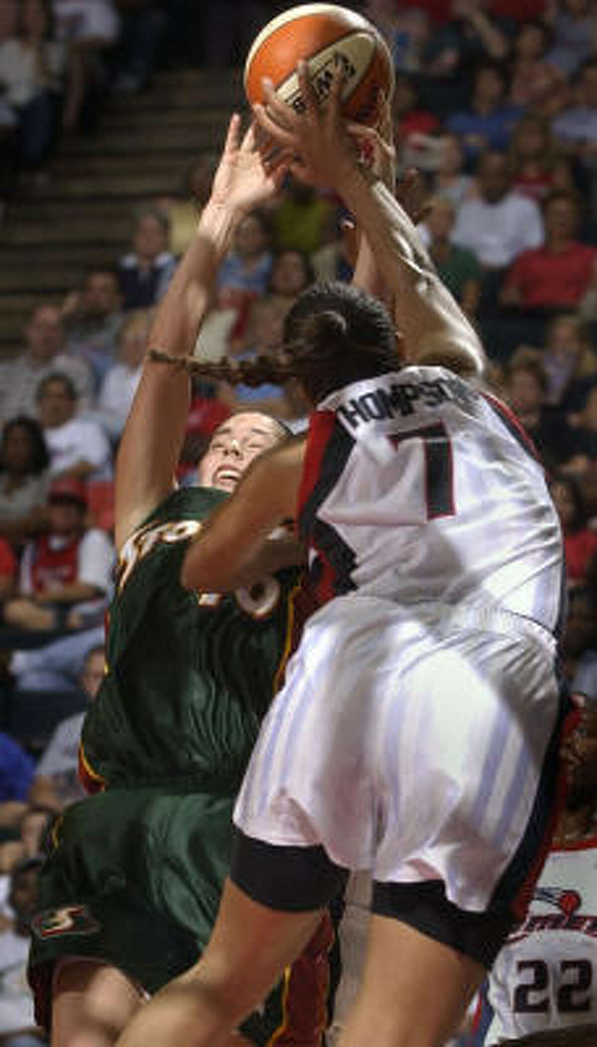 Tina Thompson (7) gets the best of Sue Bird in this encounter from a 2002 game.