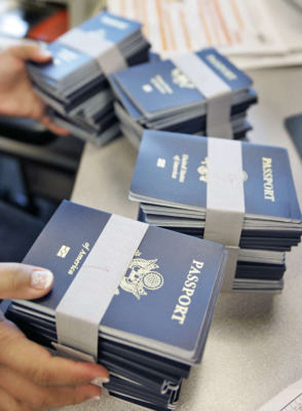 Passports are spread out before information is applied to them, as agents work to reduce the passport backlog at the New Orleans Passport Agency last month.