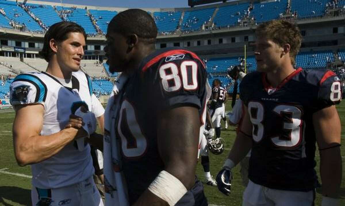 Former Texans quarterback David Carr greets two of his former receivers, Andre Johnson and Kevin Walter, after the game.