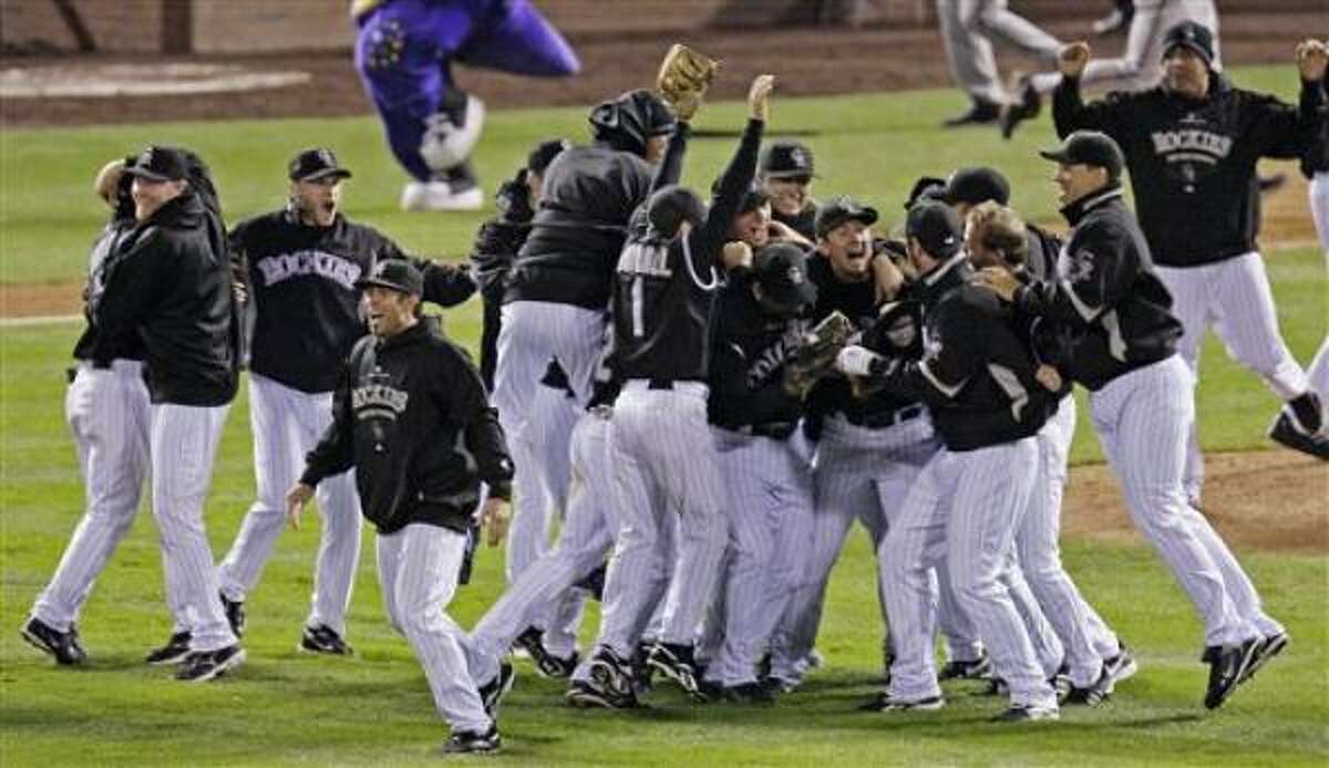 The Colorado Rockies react after the final out.