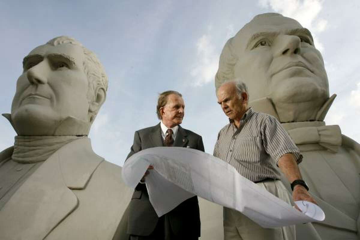 Developer Richard Browne, left, and artist David Adickes chat in front of Adickes' presidential busts. Browne is planning a presidential park and mixed-use development near Pearland that would display Adickes' busts.
