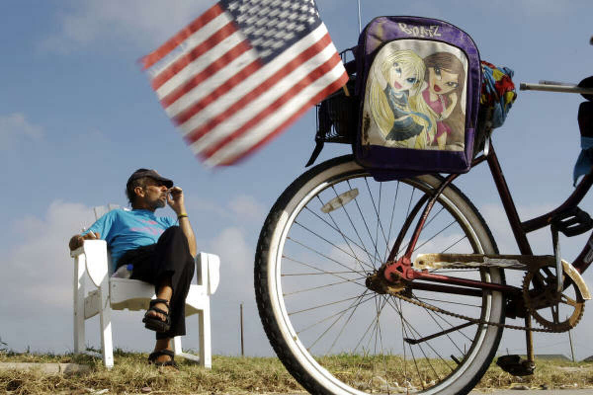 Randall Dowdell listens to church service on the radio on the back of his bike in Galveston.