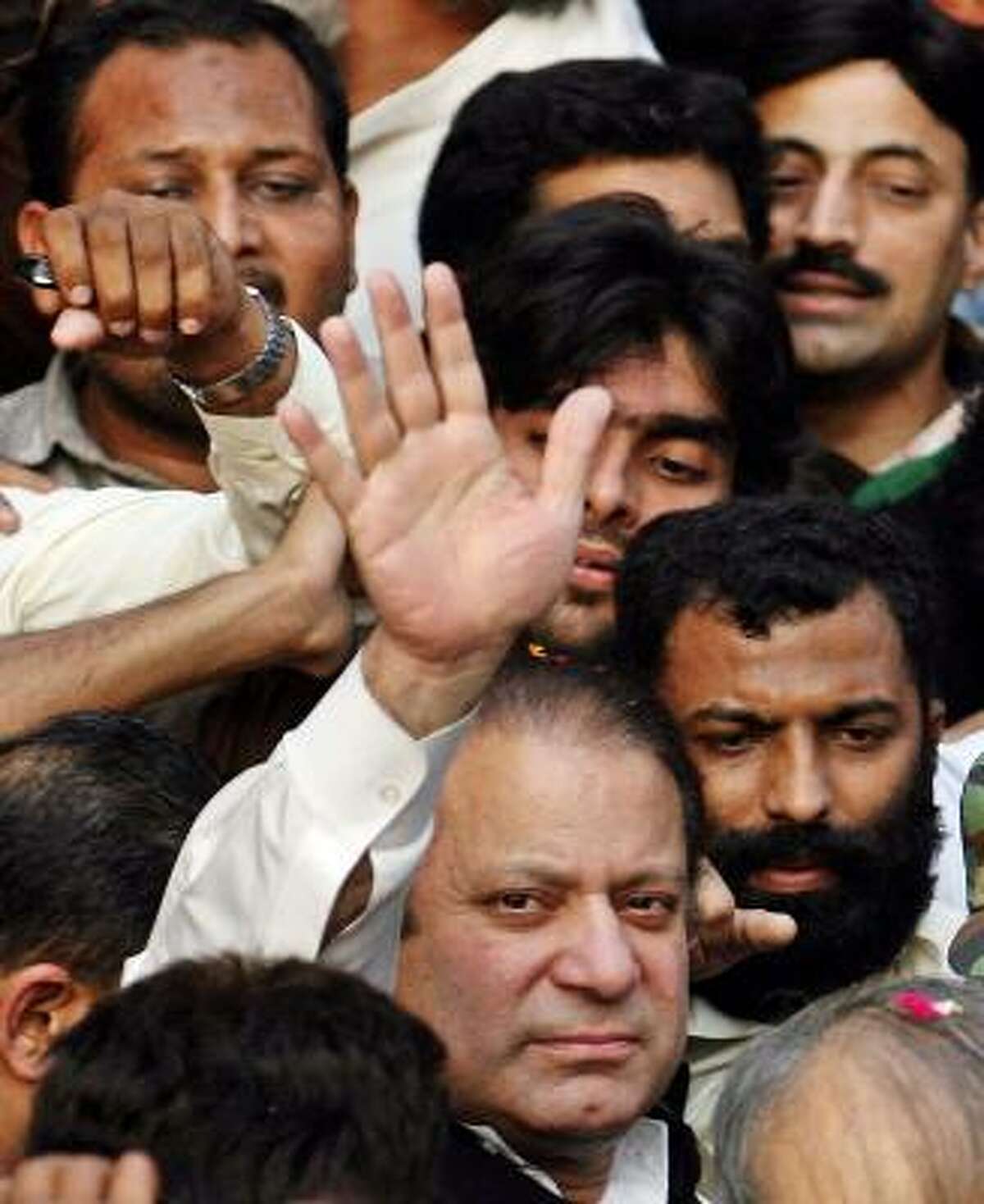 Former Pakistani Premier Nawaz Sharif waves to supporters upon his arrival Monday in Lahore, Pakistan, to submit his registration for the January general elections.