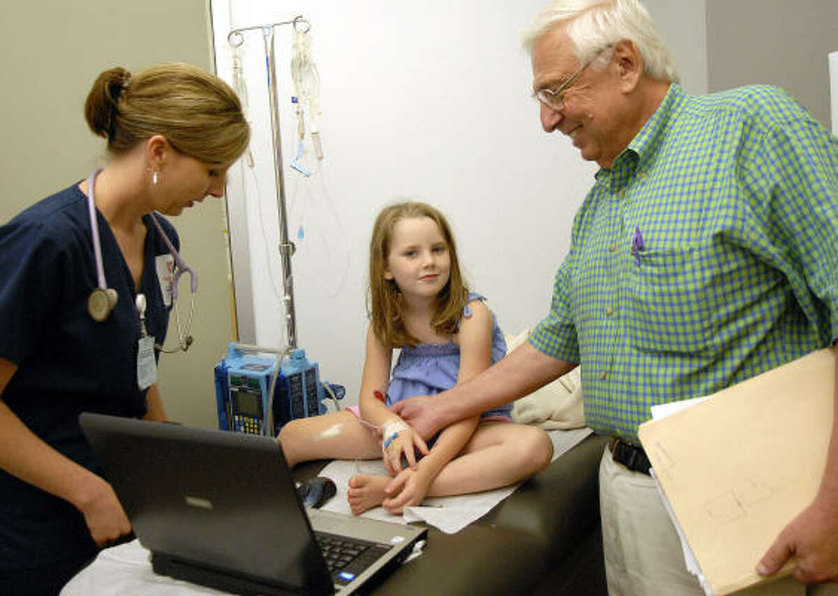 Dr. Alvin Jaffee, one of eight retired physicians in the area who volunteered to teach a health assessment lab to first-year students enrolled in the UT Health Science Center's accelerated degree program, with nursing student Sylvia Brown and Amy Schohet, 6.