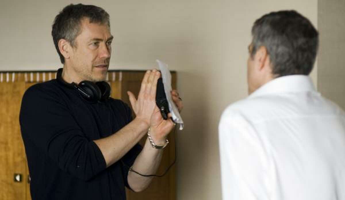 Director Tony Gilroy, left, and George Clooney discuss the best way to shoot a scene during filming of Michael Clayton.