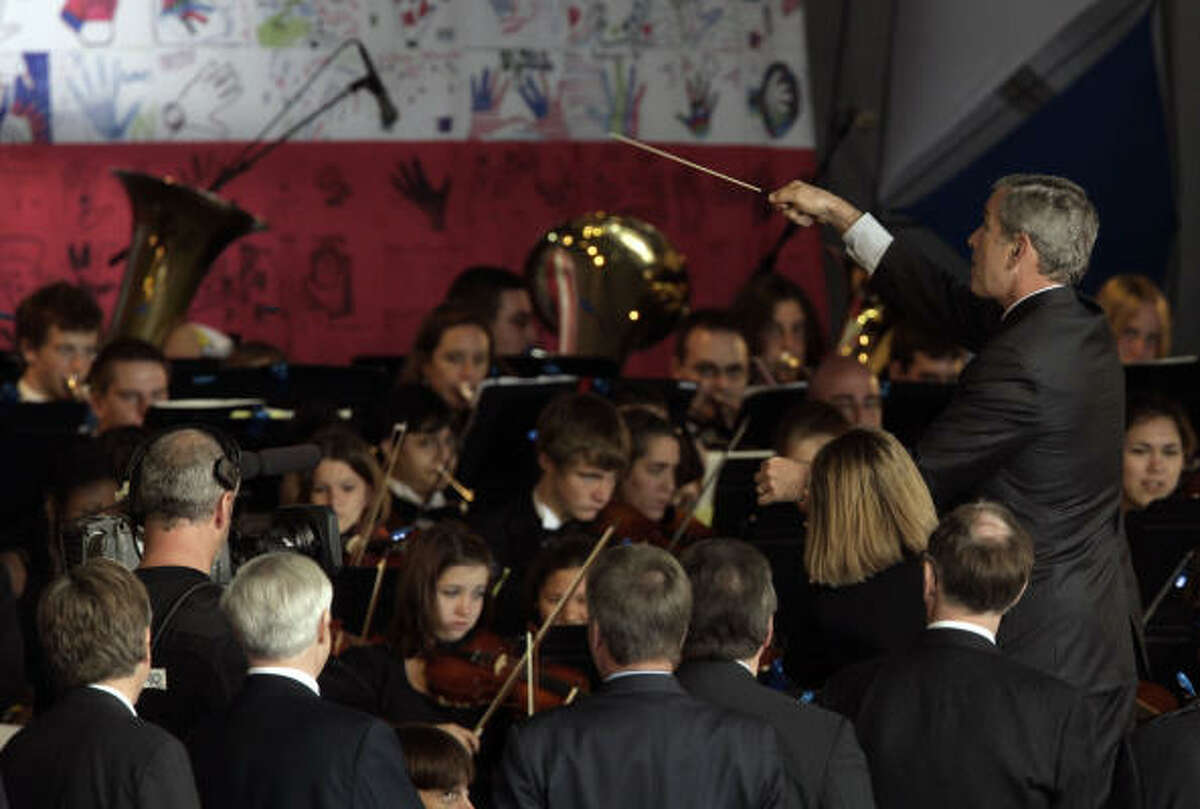 President Bush playfully directs an orchestra after making remarks during ceremonies marking the 400th anniversary of the founding of Jamestown in Jamestown, Va., on Sunday.