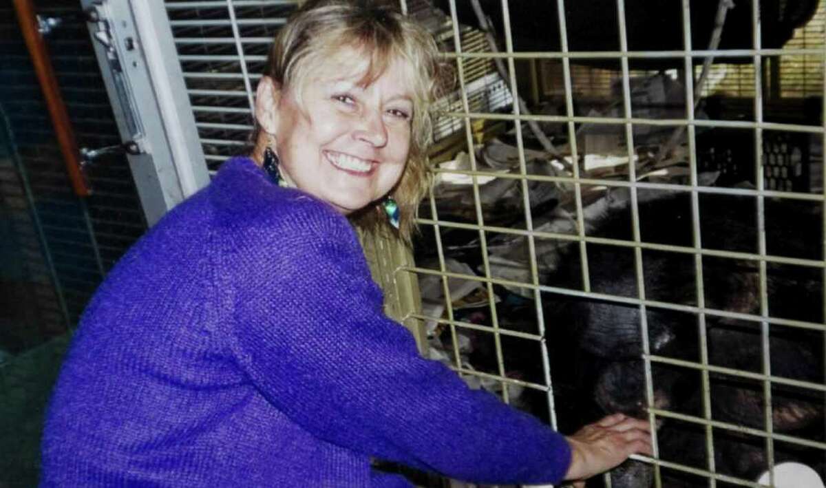 Charla Nash in a 2007 photo next to the cage with the chimpanzee Travis. Travis mauled Nash in February 2009 leaving her without any hands or eyes. Nash had a full face transplant in May at Brigham and Women's Hospital in Boston.