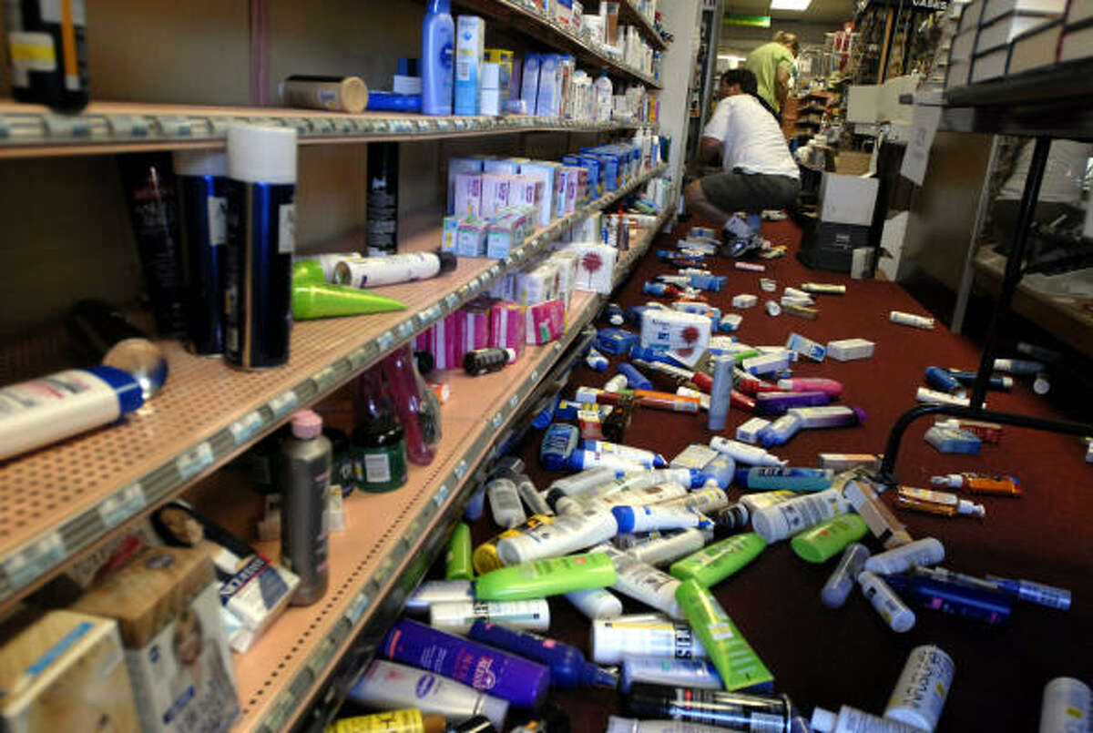 Shampoo bottles and other personal care products litter the floor at the Montclair Pharmacy and Book Tree in the Montclair Village after an early morning earthquake in Oakland, Calif., on Friday.