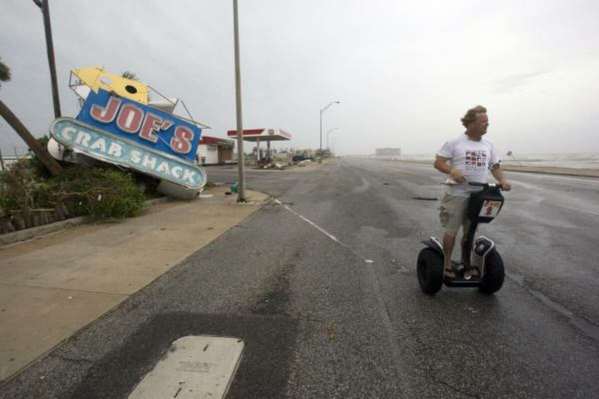 Daryl Secteau of Galveston rides on a Segway assessing the damage Hurricane Ike caused along Seawall Boulevard.