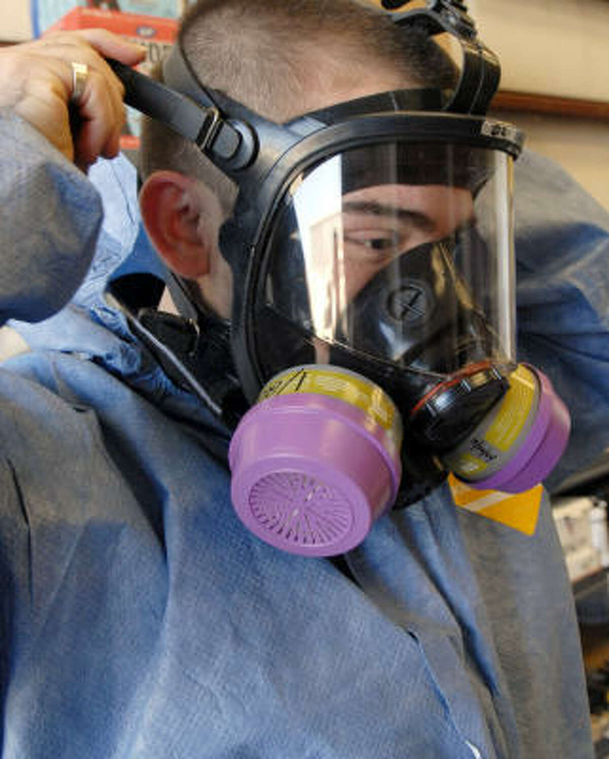 Justin DiGulio dresses in the protective clothing that is worn when cleaning up crime scenes, suicides, houses, and commercial property.