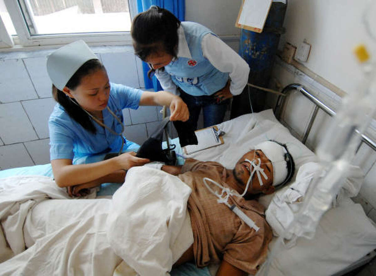 A man injured in Monday's bridge collapse in Fenghuang receives treatment at an area hospital in Hunan province.