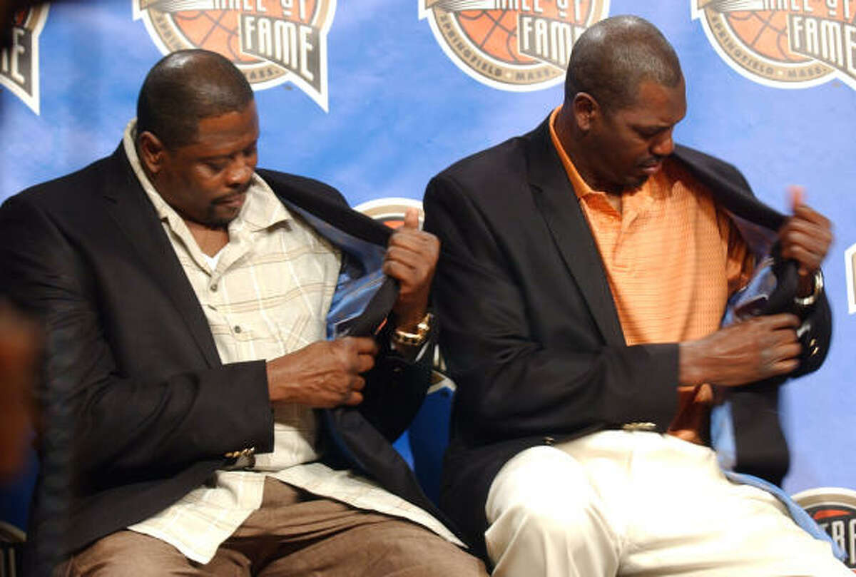 Former NBA players Patrick Ewing, left, and Hakeem Olajuwon check out their new Basketball Hall of Fame jackets.