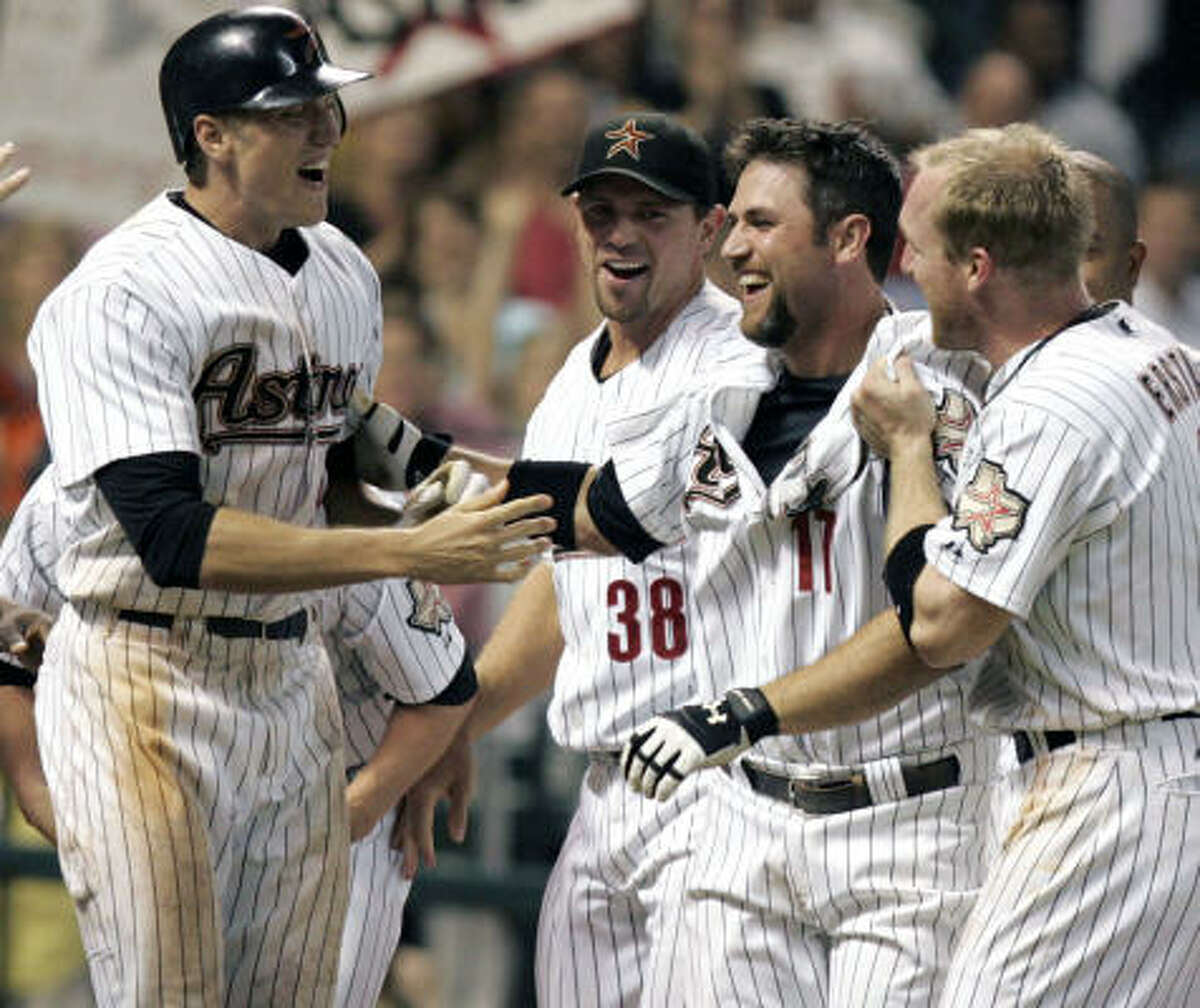 Astros first baseman Lance Berkman (second from right) is congratulated by teammates Hunter Pence, left, Brian Moehler (38) and Darin Erstad on his first career walk-off home run helped the Astros defeat the St. Louis Cardinals 3-2 on Thursday night at Minute Maid Park.