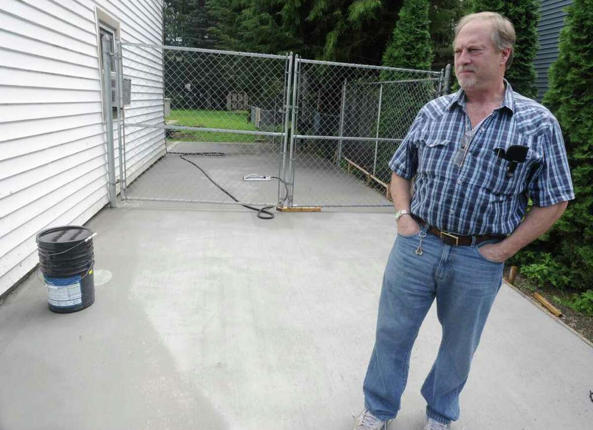 Rich Casullo stands in his driveway at his home in Charlton, N.Y. on Monday, Aug. 8, 2011. A contractor who was supposed to do the concrete job walked away after accepting half the cost and Casullo had to hire another company to finish the job. (Lori Van Buren / Times Union)