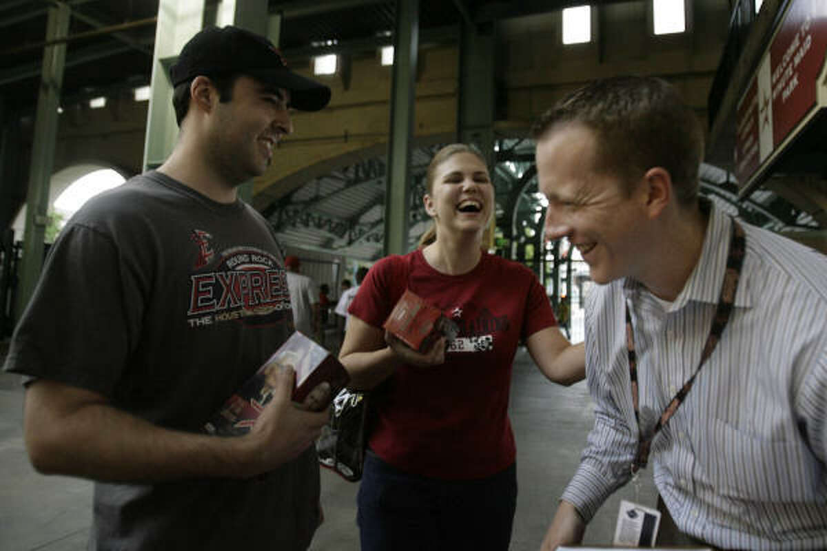 Game 1, Diamondbacks versus Astros, August 15, 2008: Aaron Robertson, left, and his wife Leslie Robertson, of Clear Lake, laugh with Clint Pasche, director of marketing for the Houston Astros.