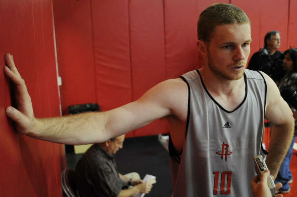 Maarty Luenen rests his right arm on a wall at Houston Rockets practice in Toyota Center, Thursday, prior to summer league.