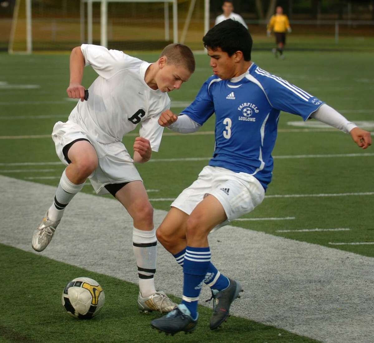 Trumbull's John Sullivan, left, works to keep the ball away from Fairfield Ludlowe attacker Fernando Pabon during Monday's FCIAC matchup at Trumbull High School.