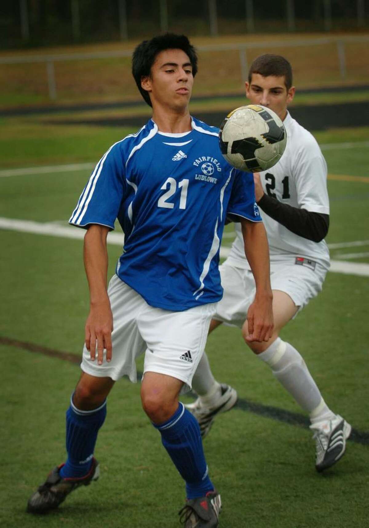 Fairfield Ludlowe's Christan Barral plays the ball in front of Trumbull defender Matthew Romano during Monday's FCIAC matchup at Trumbull High School.