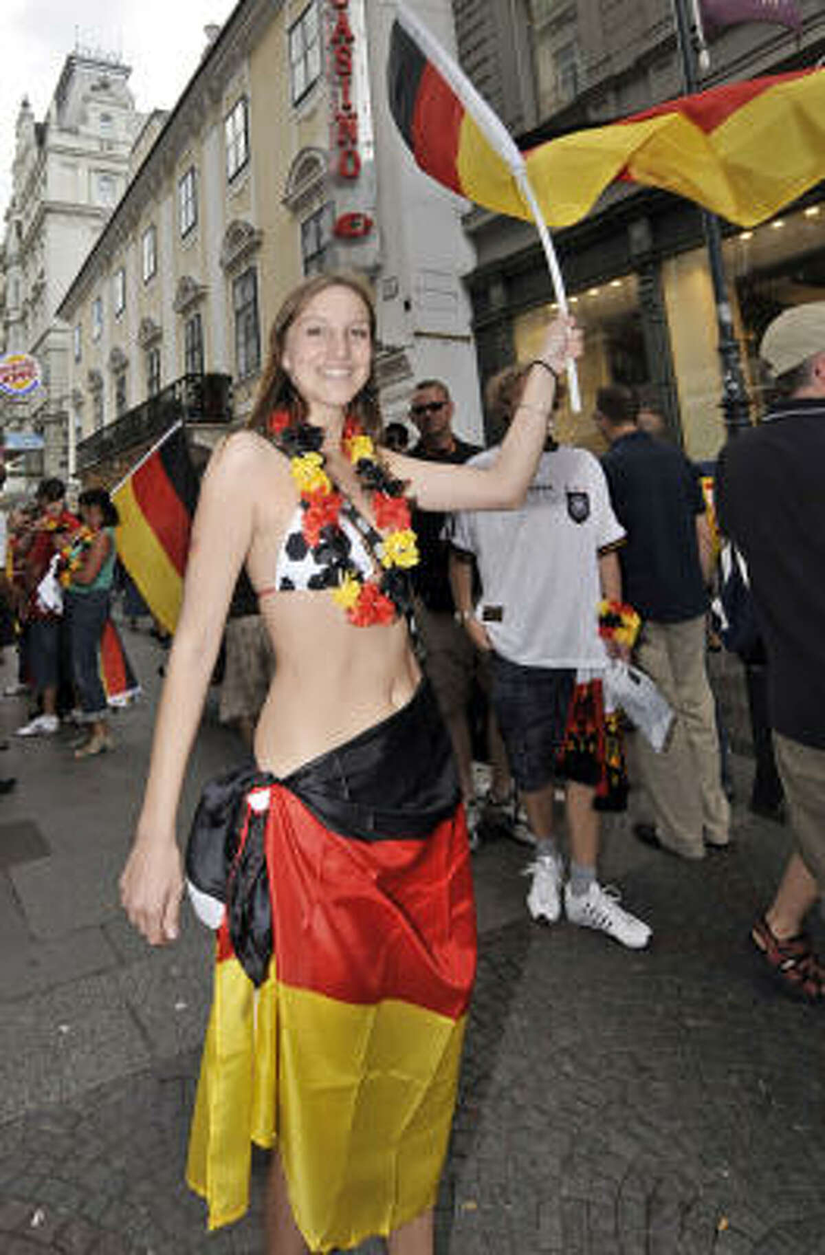A German fan cheers waving the German flag in downtown Vienna prior to the Euro 2008 European Soccer Championships final between Germany and Spain.