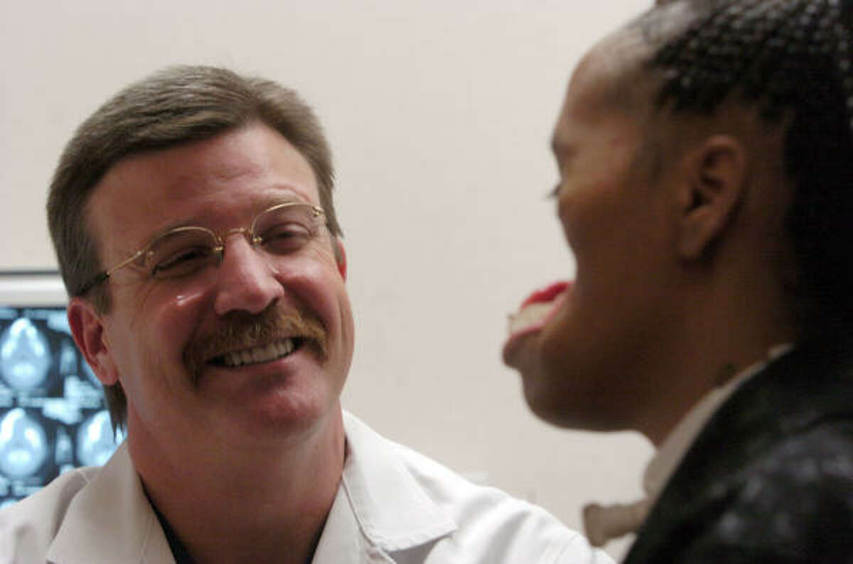 Dr. Eugene Alford shares a laugh with Carolyn Thomas as she meets with doctors at The Methodist Hospital on Thursday, Feb. 3, 2005. Carolyn's face was destroyed after being shot on Dec. 2003 by her then boyfriend, Terrence Kelly.