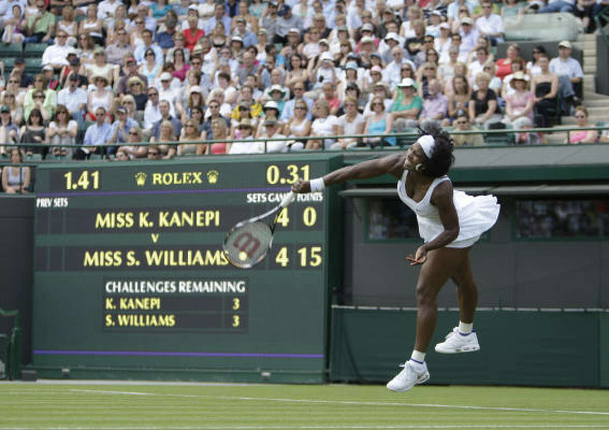 Defending champion Serena Williams serves to Estonia's Kaia Kanepi in the first round.