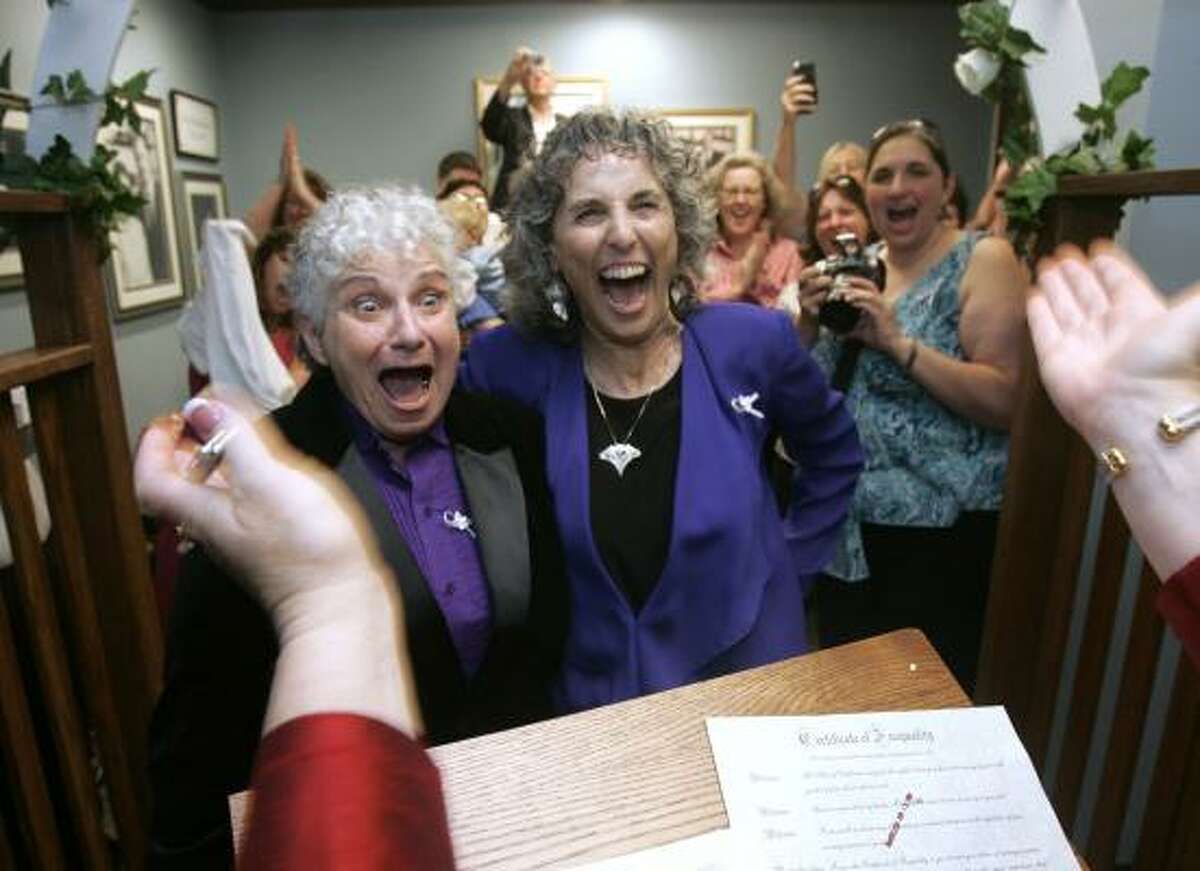 Shelly Bailes, left, and Ellen Pontac react after Yolo County Clerk/Recorder Freddie Oakley pronounces them married during a wedding ceremony in Woodland, Calif., Monday.