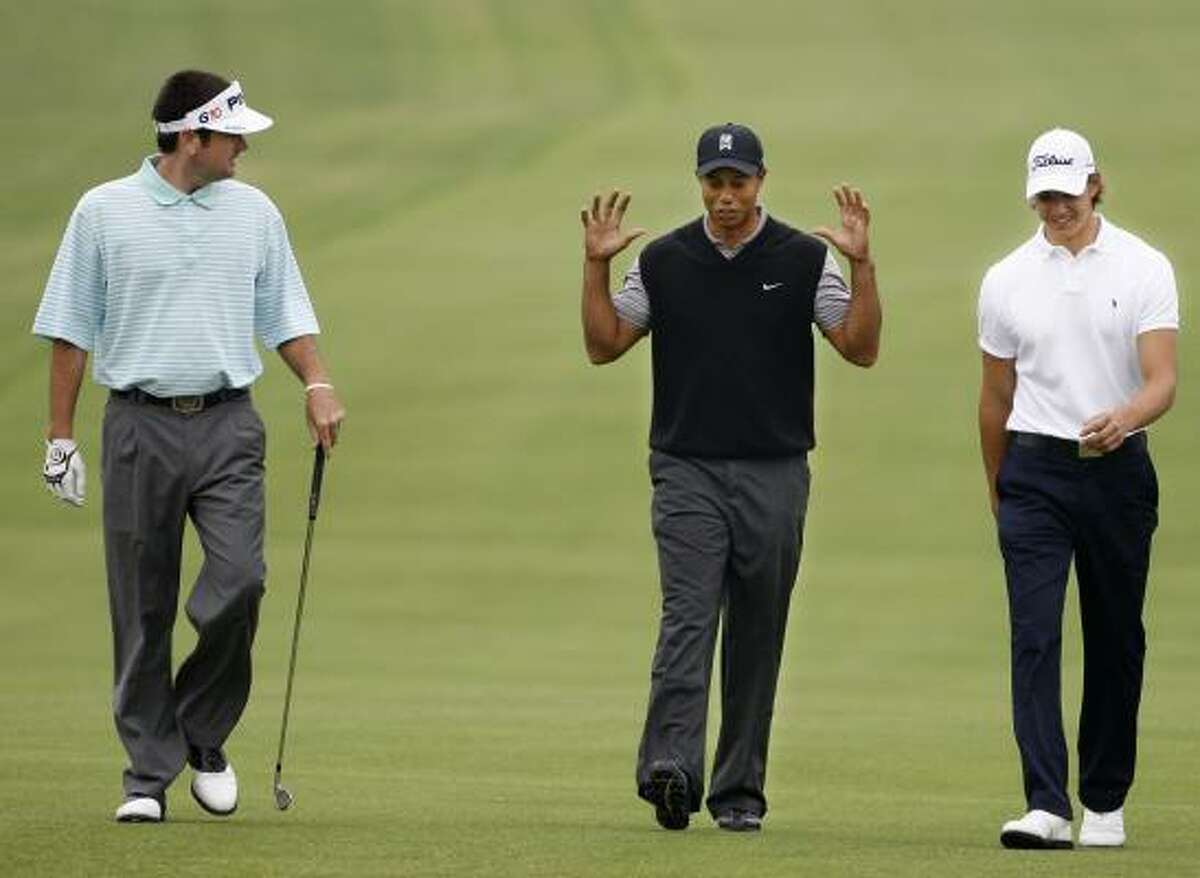 Tiger Woods, center, talks with fellow golfers Bubba Watson, left, and Jordan Cox during a practice round at Torrey Pines on Monday.