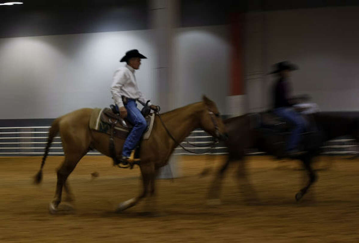 Riders warm up before the cutting horse competition at Reliant Arena Wednesday.