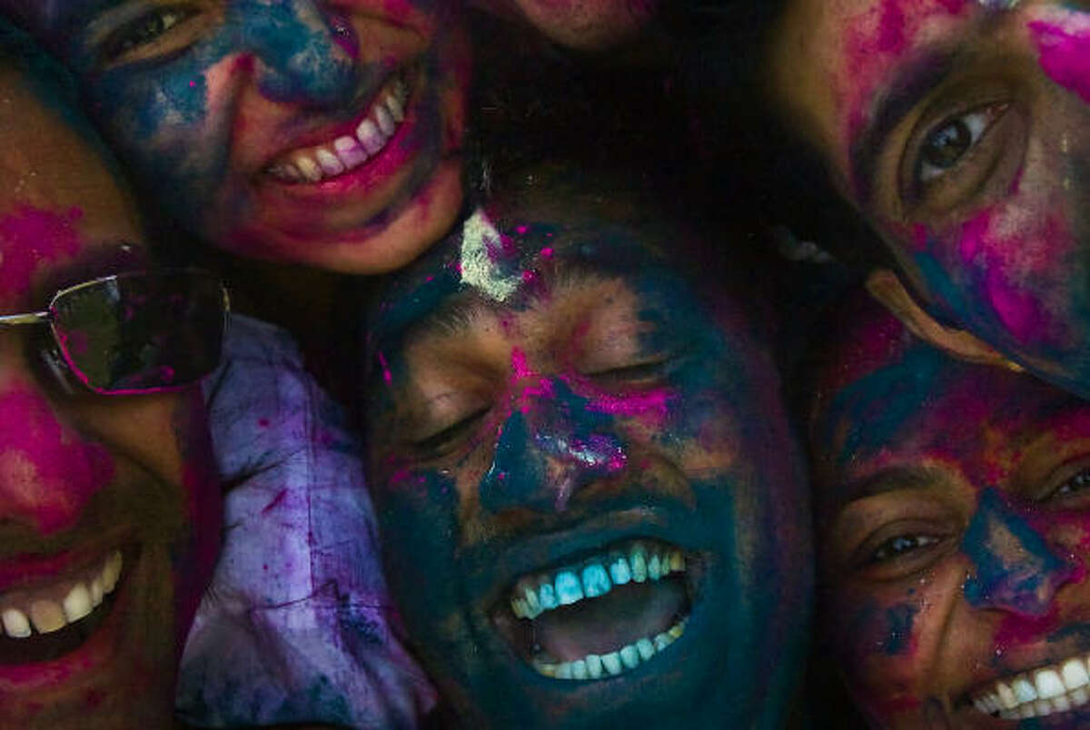 A group of friends press their faces together during festivities celebrating the Hindu holiday of Holi, Sunday, March 23, 2008.