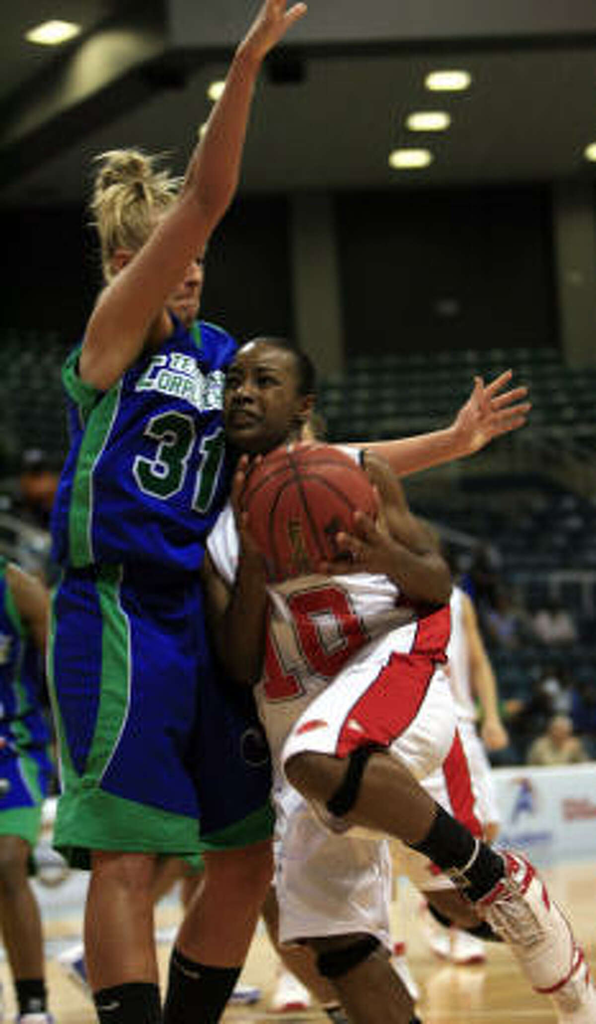 Lamar's Nikki Williams, right, works to get ardound Sarah Davidson of Texas A&M Corpus Christi during the second half . Williams scored 19 points lead the Lady Cardinals to a 63-50 victory in the Southland Conference women's semifinals.