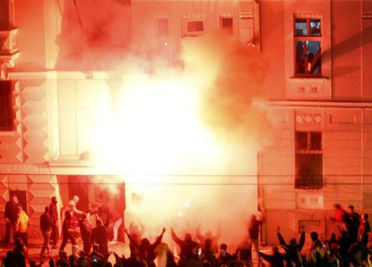 The U.S. embassy in Belgrade burns.