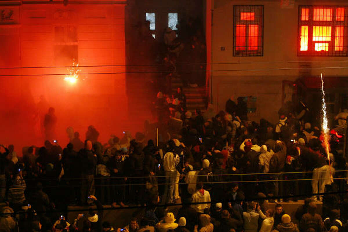 Serbian nationalists storm and set afire the U.S. embassy.