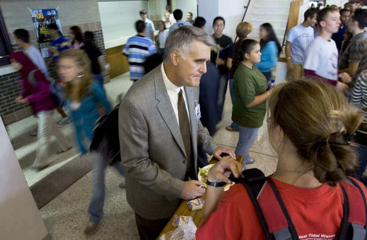 Principal James May, shown during a busy lunch period at Kempner High School, says playing dress-code referee is rarely easy.