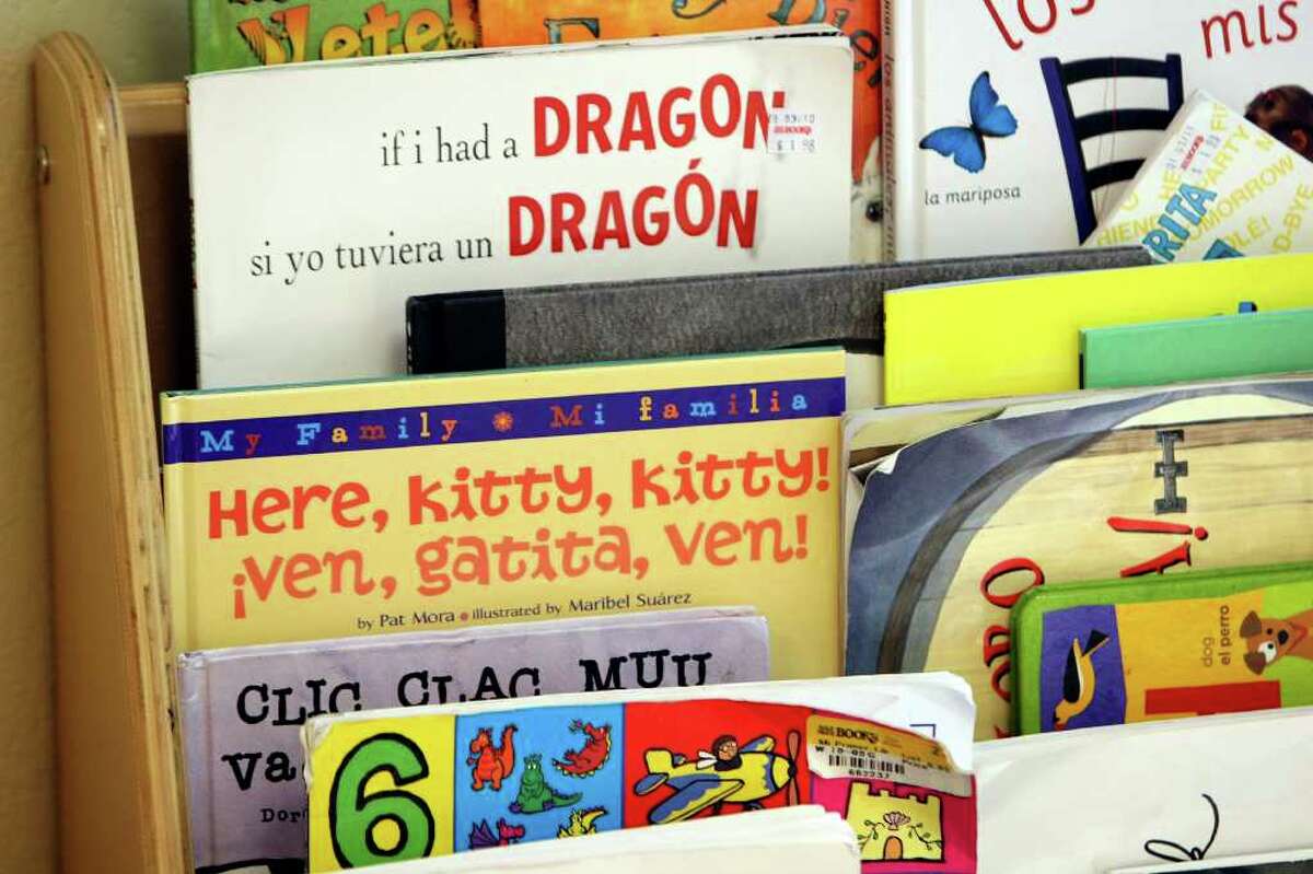 Bilingual books st in a rack at the Pineapple school, a Spanish-language immersion preschool that opened last year with 60 kids. They are now full and have a waiting list.