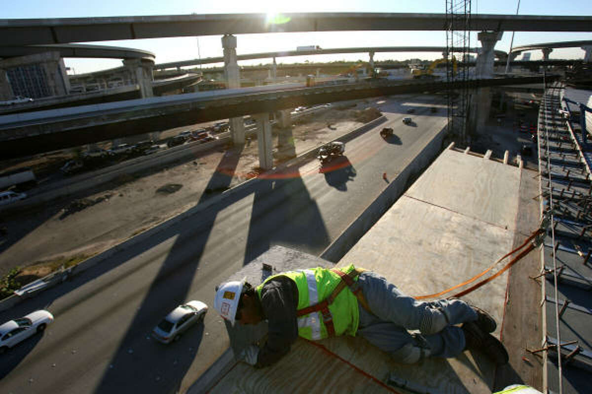 Jesus Ponce works on the Katy Freeway and Beltway 8 interchange connector on Friday, Jan. 11.