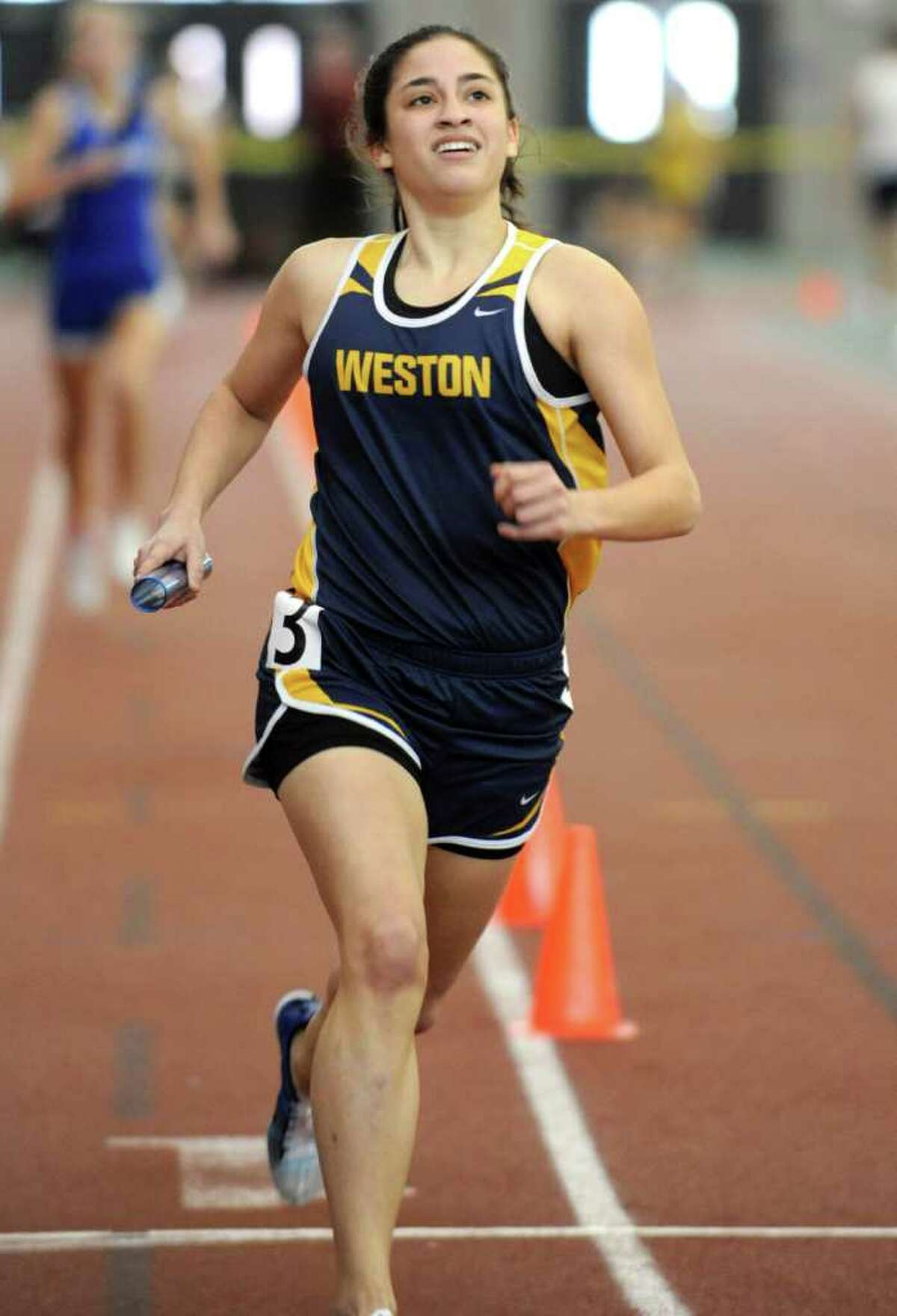 Kara Bucaro competes in the girls sprint medley relay race for Weston at the Class M championships. Bucaro anchored the sprint medley relay team to success by running the 800-meter leg and begins training camp Sunday with Towson State University's cross country team.