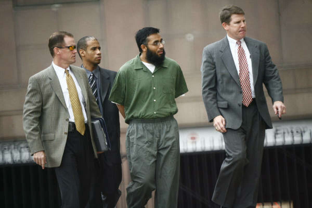 Shiraz Qazi, center, arrives at Houston's federal courthouse Wednesday accompanied by FBI agents. He is the cousin of Adnan Mirza, who is one of two men charged with aiding the Taliban.