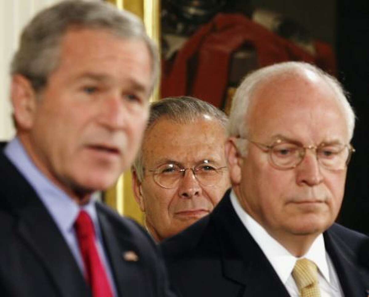 Secretary of Defense Donald Rumsfeld, center, and Vice President Dick Cheney listen to President Bush speak before the signing of the Military Commissions Act of 2006 in the East Room of the White House.