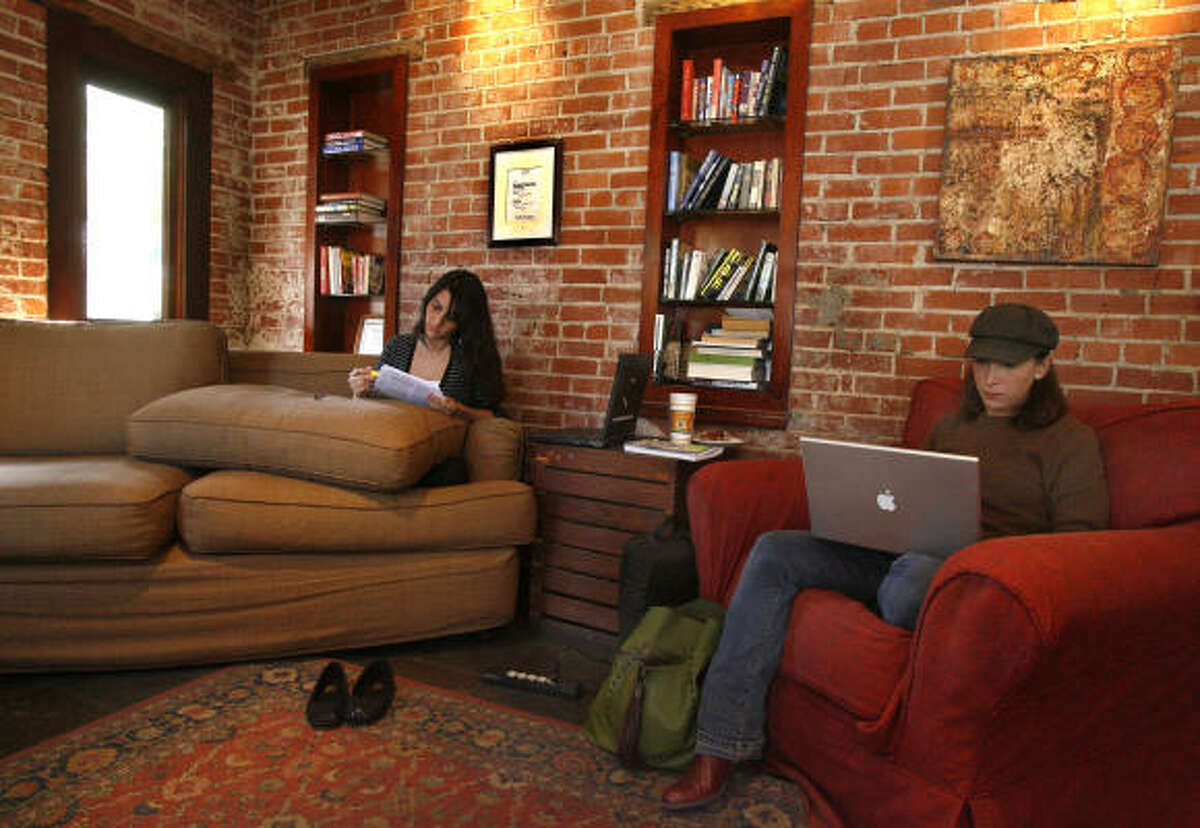 Jennifer Gonzalez-Reinhart, left, and Anastasia Pappas curl up with coffee and their work at Diedrich Coffee on Westheimer before the hangout closed last week. The details of what led to the lease not being renewed are not clear.