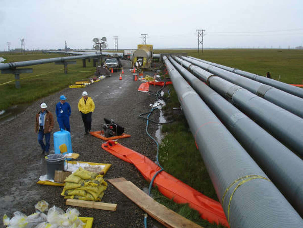 Workers gather at the site of the leak at BP's Prudhoe Bay, Alaska, facility on Monday. The pipeline produces 8 percent of U.S. crude demand.