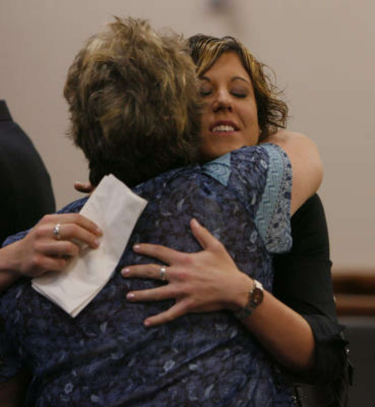 Eva Rowe, right, embraces Carol Ware, a secretary for her attorney, after reaching a settlement Thursday with BP in the deaths of her parents. Rowe, 22, has vowed to use some of the money to crusade for workplace safety nationwide.
