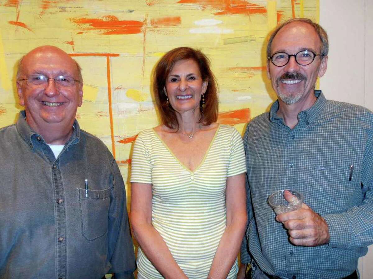 Mike Schroeder, Donna Simon and exhibit curator Larry Graeber gather in front of one of Graeber's paintings at the closing of "Margins" at the UTSA Art Gallery. Photo by Nancy Cook-Monroe
