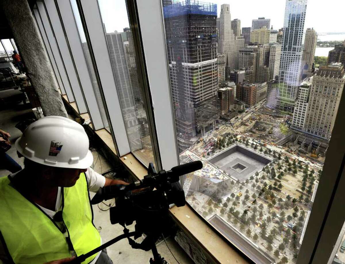 A cameraman documents the footprints of the World Trade Center towers from the 39th floor of the Freedom Tower, also known as One World Trade Center, New York City, Thursday, Aug. 11, 2011, under construction a month before the 10th anniversary of 9/11. Bob Lucky/Hearst Newpapers