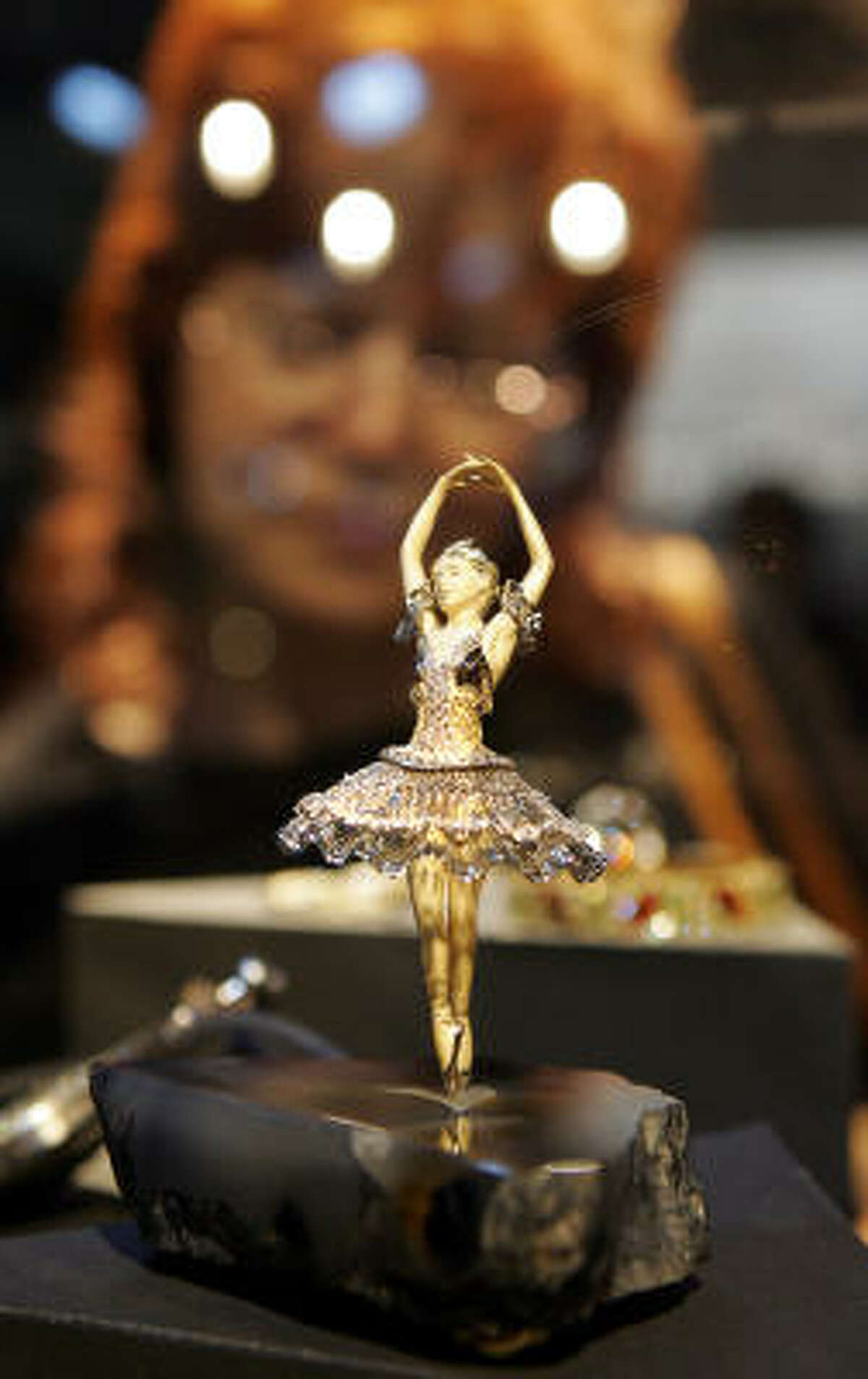 A ballerina statue decorated in diamonds draws admiring glances Thursday.