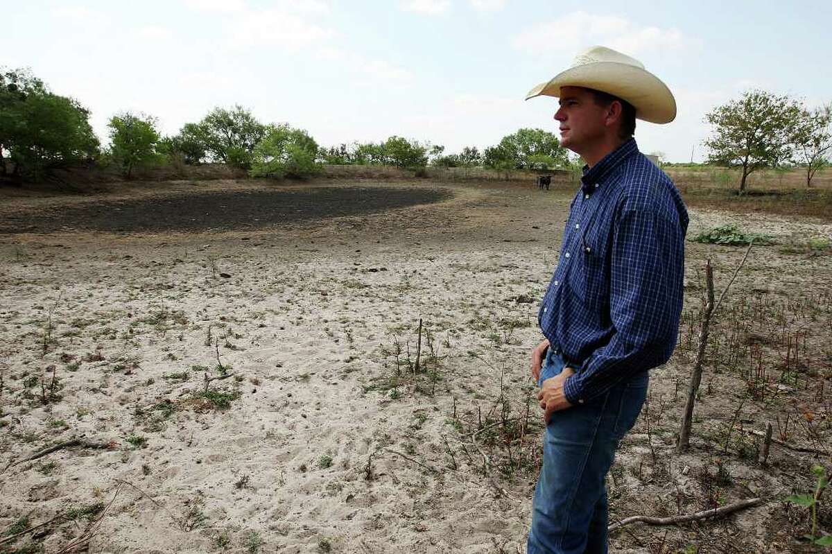 Cattle rancher Ty Keeling looks over a dried-up stock tank on a neighboring rancher’s land in Wilson County.