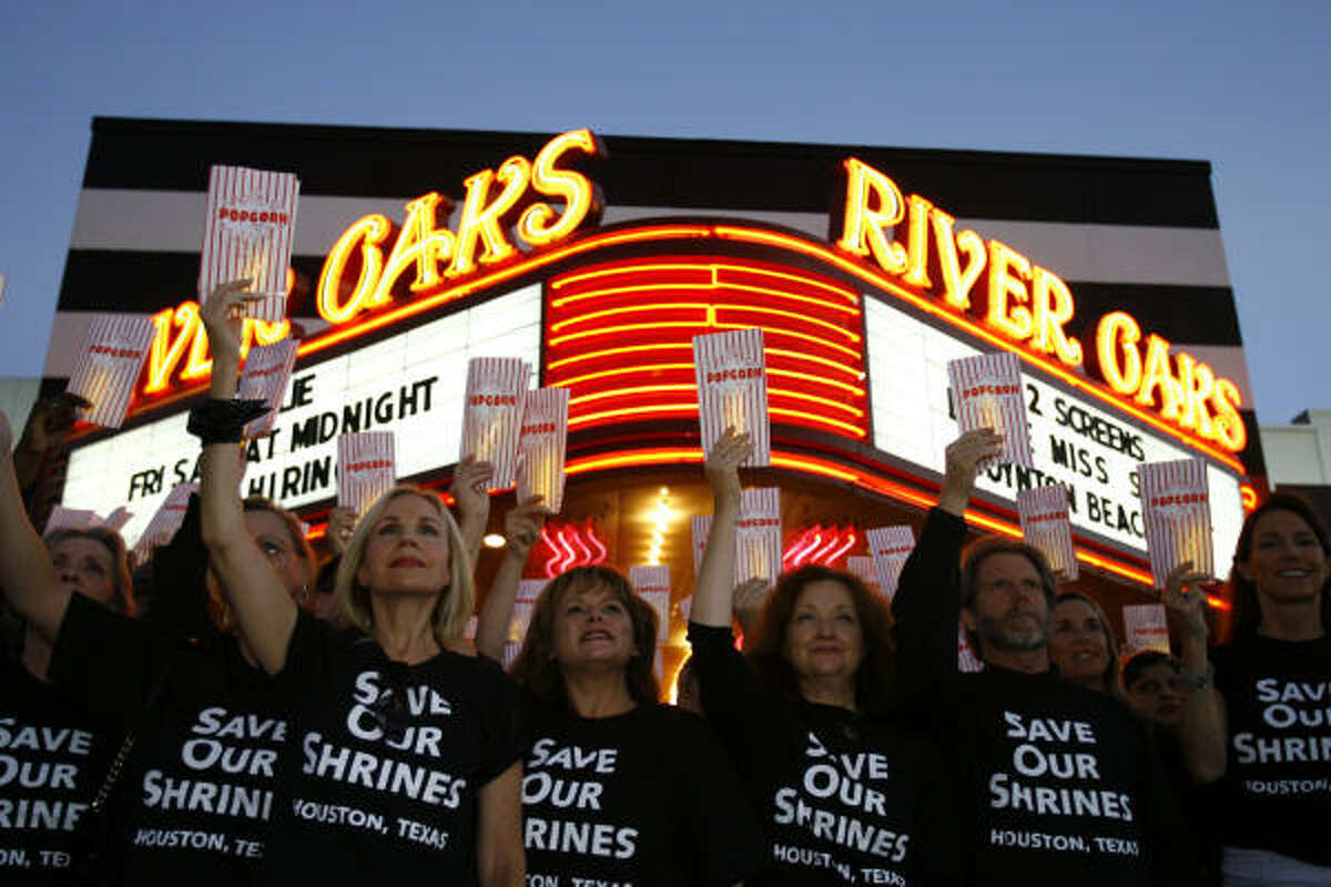 Members of the Save Our Shrines group gather for a publicity photo outside the River Oaks Theatre.