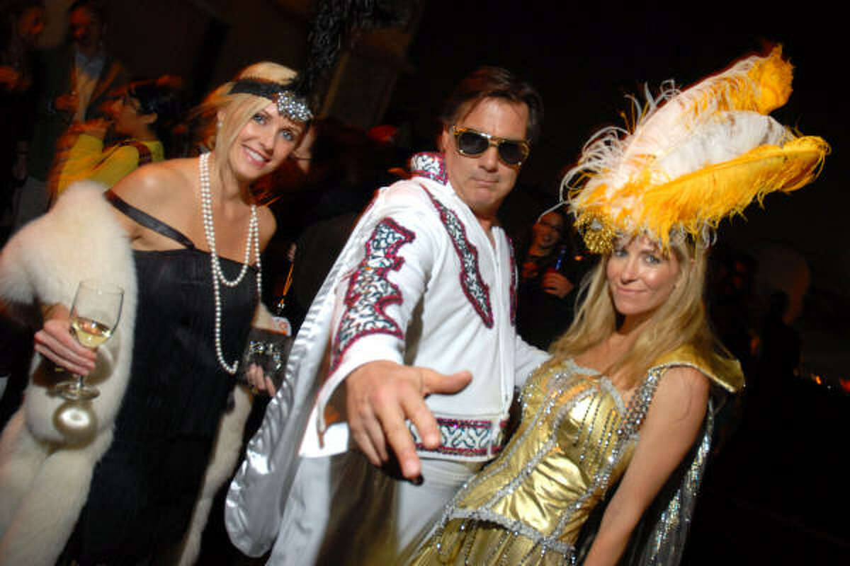 Joyce Echols, left, gets into the spirit of the zany evening with Greg and Laura Casey.