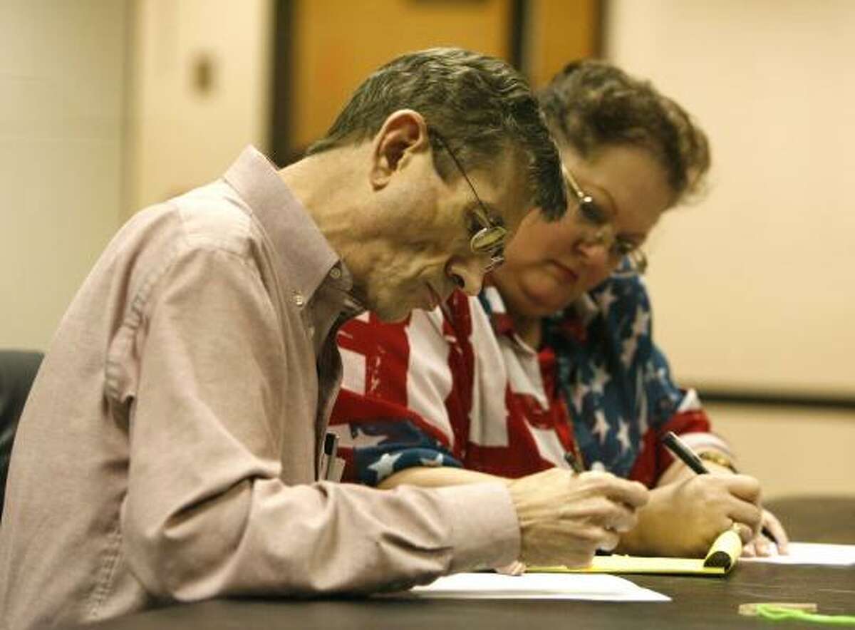 Harris County Early Voting Ballot Board members Michael Kelley, a Democrat, and Kathy Haigler, a Republican, tally votes in downtown Houston.