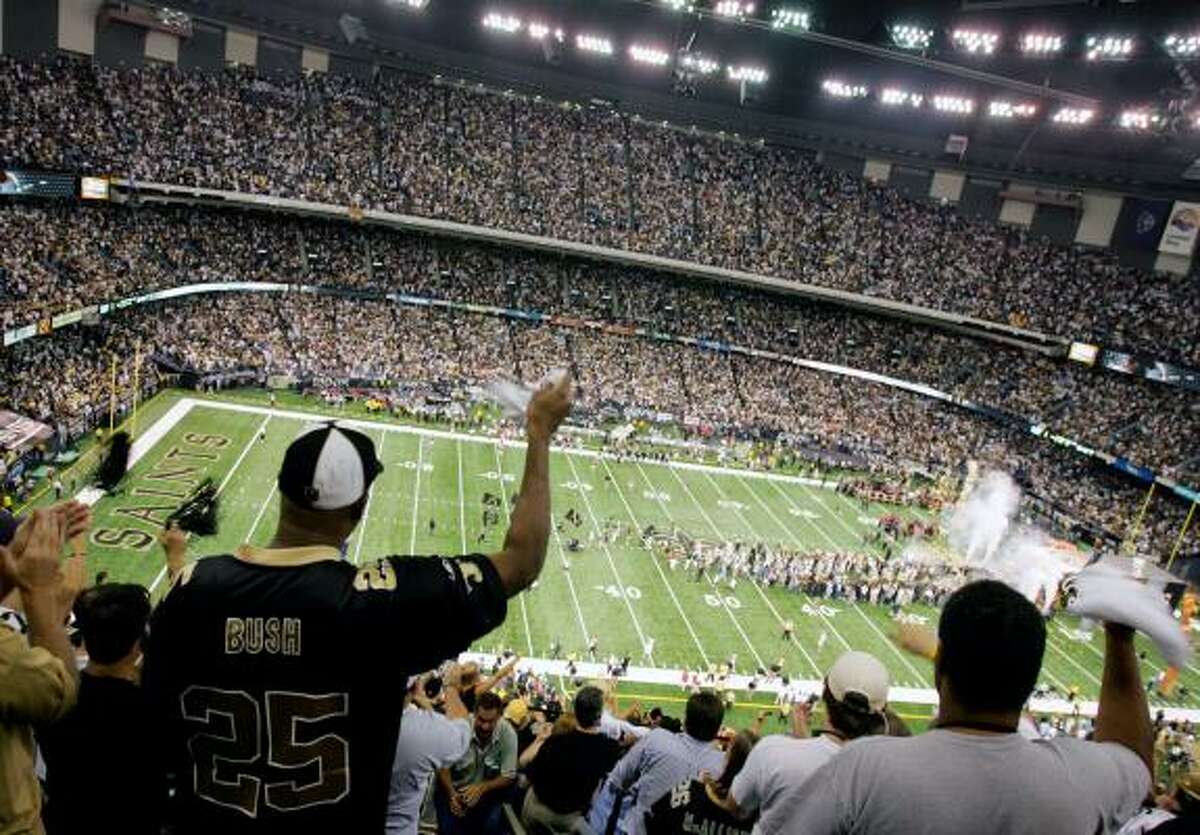 New Orleans Saints fans cheer as their team takes the field at the Louisiana Superdome before Monday's game, the first one played at the dome since December 2004.