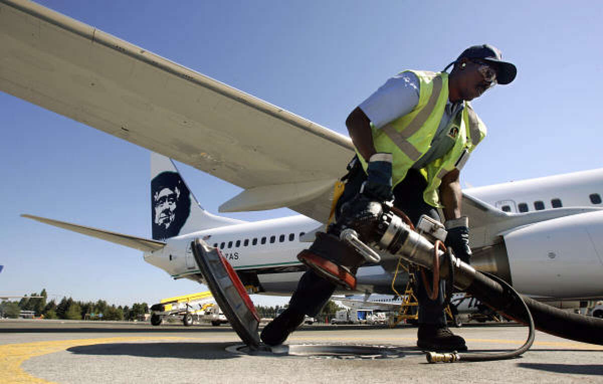 Dave McQueen pulls a hose from a hydrant fueling system after refueling an Alaska Airlines 737-800 jet at Seattle-Tacoma International Airport. The airline has practiced fuel hedging, which has helped it endure the global rise in oil prices.